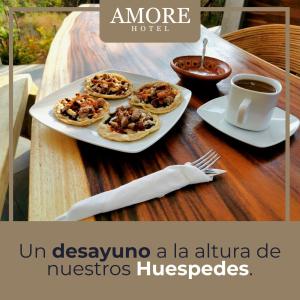 a table with plates of food and a cup of coffee at Casa A'more in Cuatunalco