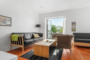 a living room with a couch and a table at 20424-Samso-Besser-Kirkevej-4-C in Langemark