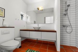 a bathroom with a toilet and a sink and a shower at 20424-Samso-Besser-Kirkevej-4-C in Langemark +21 photos
