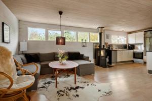 a living room with a couch and a table at 30732-Odder-Skovgardsparken-32 in Amstrup