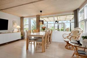 a dining room with a table and chairs at 30732-Odder-Skovgardsparken-32 in Amstrup
