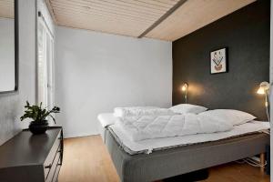 a bedroom with a large bed in a room at 30732-Odder-Skovgardsparken-32 in Amstrup