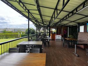 リオネグロにあるHotel & Golf Isak Aeropuertoのテーブルと椅子、バルコニー付きのレストラン