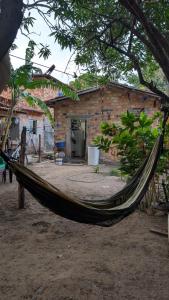a hammock in front of a brick building at Hospedagem Tia Lene Pacoval Soure in Soure