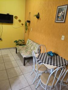 a table and chairs and a couch in a room at Kitinet Verolme AFP 1 in Angra dos Reis