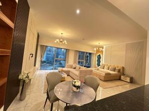 a living room with a couch and a table and chairs at Central Park towers residence difc in Dubai