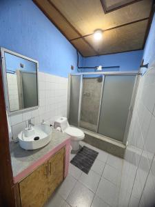 a bathroom with a sink and a toilet at Casa Azucena in Flores +9 photos