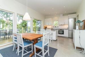 a kitchen and dining room with a wooden table and chairs at BLE833-Lyckeby-Knoesoevaegen-98 in Lyckeby