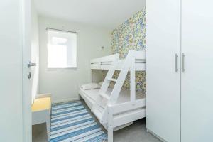 a bedroom with two bunk beds and a window at BLE833-Lyckeby-Knoesoevaegen-98 in Lyckeby