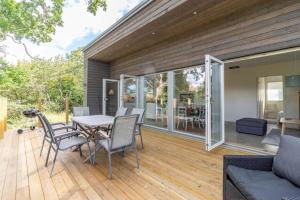 a patio with a table and chairs on a wooden deck at BLE833-Lyckeby-Knoesoevaegen-98 in Lyckeby