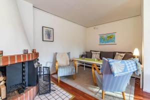 a living room with a couch and a table at KRO802-Haeradsbaeck-Ellagoelshult-3 in Gäddegölshult