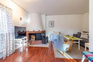 a living room with a table and a fireplace at KRO802-Haeradsbaeck-Ellagoelshult-3 in Gäddegölshult