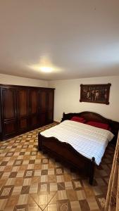 a bedroom with a large bed with wooden cabinets at Casa Mario 1 in Drobeta-Turnu Severin