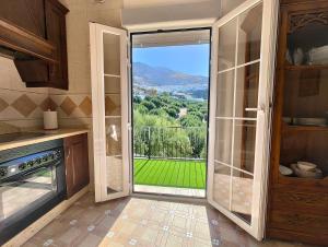 a kitchen with a sliding glass door with a view at Alojamiento La Nave de Zuheros in Zuheros