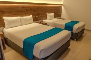 a hotel room with two beds in a room at Antawa Classic in Moquegua