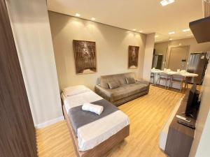 a living room with a bed and a couch at LK Santo Agostinho 7 in Belo Horizonte