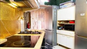 a small kitchen with a sink and a refrigerator at Sams Rooms - Solo Female Guest House in Amadora +45 photos
