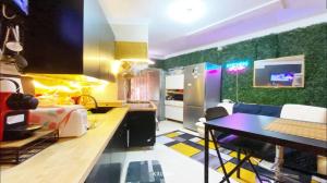 a kitchen with a counter and a table in a room at Sams Rooms - Solo Female Guest House in Amadora
