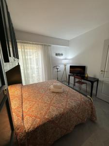 a bedroom with a bed with two towels on it at Lisa Apartment in Menton +28 photos