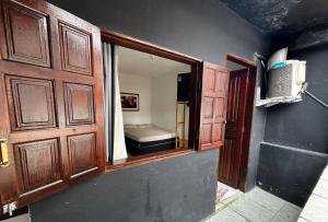 an open door to a room with a bed at Toca do Pato Pousada in Trindade