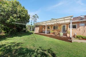 a backyard of a house with a pergola at Luxury 3 bedroom 2 bathroom full home with easy access near Cronulla in Lilli Pilli