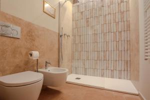 a bathroom with a toilet and a shower at SweetHome San Martino in San Gimignano +18 photos
