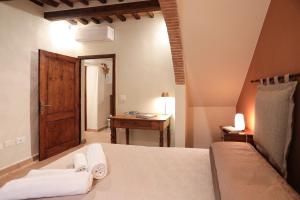 a bedroom with a bed and a wooden door at SweetHome San Martino in San Gimignano