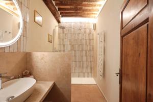 a bathroom with a sink and a toilet and a shower at SweetHome San Martino in San Gimignano