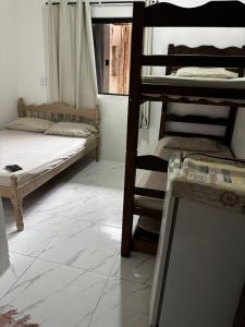 a room with two bunk beds and a table at Toca do Pato Pousada in Trindade +67 photos