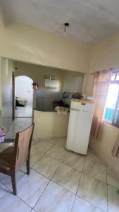 a kitchen with a table and a chair in a room at Espaço de Iguaba Grande in Iguaba Grande