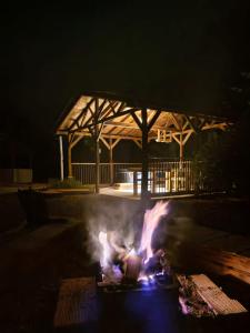 a fire in the middle of a yard at night at Fresh Start in Jardin