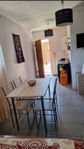 a dining room table and chairs in a kitchen at Hostal Ribera de Quitor in San Pedro de Atacama