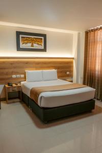 a bedroom with a large bed in a room at Antawa Hotel in Moquegua