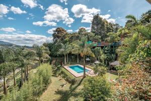 an aerial view of a resort with a swimming pool and trees at Aurora Ecoliving Finca a 30 minutos de Medellín in Girardota