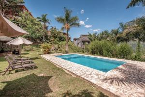 a swimming pool in the yard of a house at Aurora Ecoliving Finca a 30 minutos de Medellín in Girardota