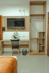 a bedroom with a desk and a bed and a bedroom with a bed sqor at Antawa Hotel in Moquegua