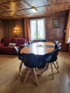 a living room with a wooden table and chairs at Bio Hof Brudersrüti in Schwarzenberg
