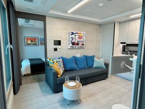 a living room with a couch and a bed at Ocean Front Apartment in Busan