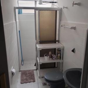 a bathroom with a shower with a toilet and a sink at Apto a 100 mts da praia no Canto do forte com 1 vaga in Praia Grande