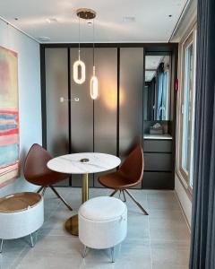 a dining room with a table and chairs at Ocean Front Apartment in Busan +59 photos