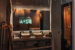 a bathroom with two sinks and a large mirror at Saccharum in Nocaima +42 photos