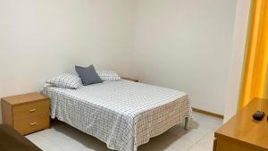 a bedroom with a bed with a blue pillow on it at Airport Residence - Vila Acácia I in Praia