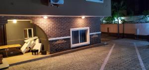 a brick building with a window on the side of it at TwinVilleCove, affordable villas located in Ajah in Obalende