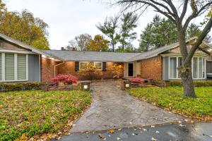 a brick house with a pathway leading to the front yard at Spacious Rochester Home with Heated Pool and Hot Tub! in Rochester
