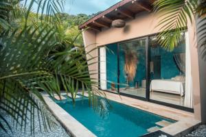 a house with a swimming pool next to a house at Saccharum in Nocaima