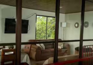 a living room with a couch and a window at Paradise Views Awaits, King Bed, Hot-Tub in Quebradas