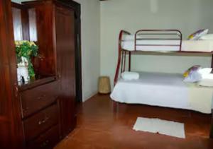 a room with two bunk beds and a dresser at Paradise Views Awaits, King Bed, Hot-Tub in Quebradas +49 photos
