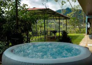 a large hot tub in a yard with a gazebo at Paradise Views Awaits, King Bed, Hot-Tub in Quebradas
