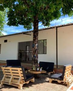 two chairs and a table under a tree at Hotel morada del sol  +11 photos