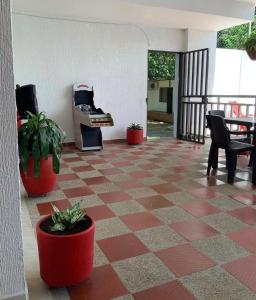 a room with a checkered floor with chairs and a piano at Hotel morada del sol 
